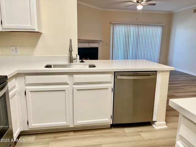 a kitchen with cabinets appliances and a counter space