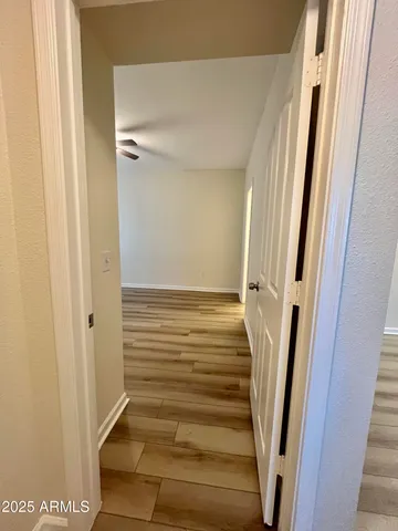 a view of staircase with white walls and door