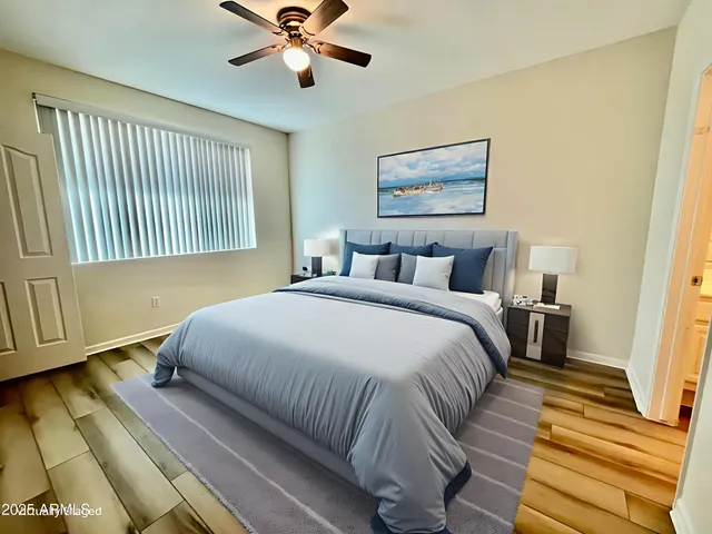 a bedroom with a bed and wooden floor