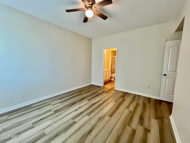a view of an empty room and wooden floor
