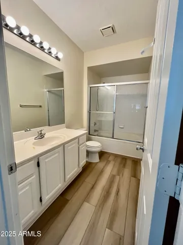 a bathroom with a double vanity sink and mirror with bathtub