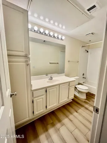 a bathroom with a double vanity sink mirror and toilet