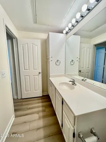 a bathroom with a double vanity sink and mirror