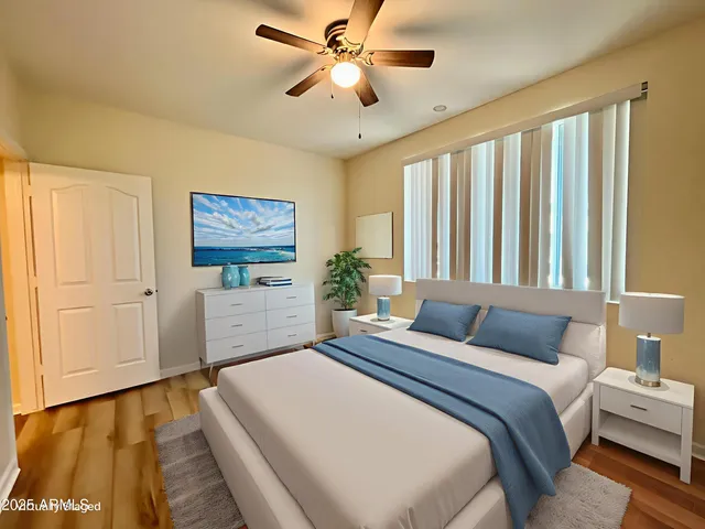 a bedroom with a large bed and a chandelier