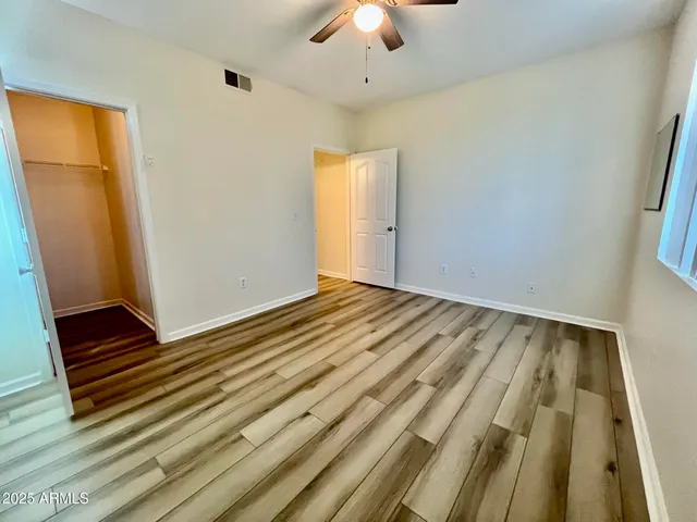 a view of a room with wooden floor