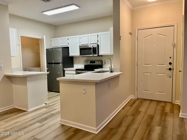 a kitchen with a refrigerator and a stove top oven