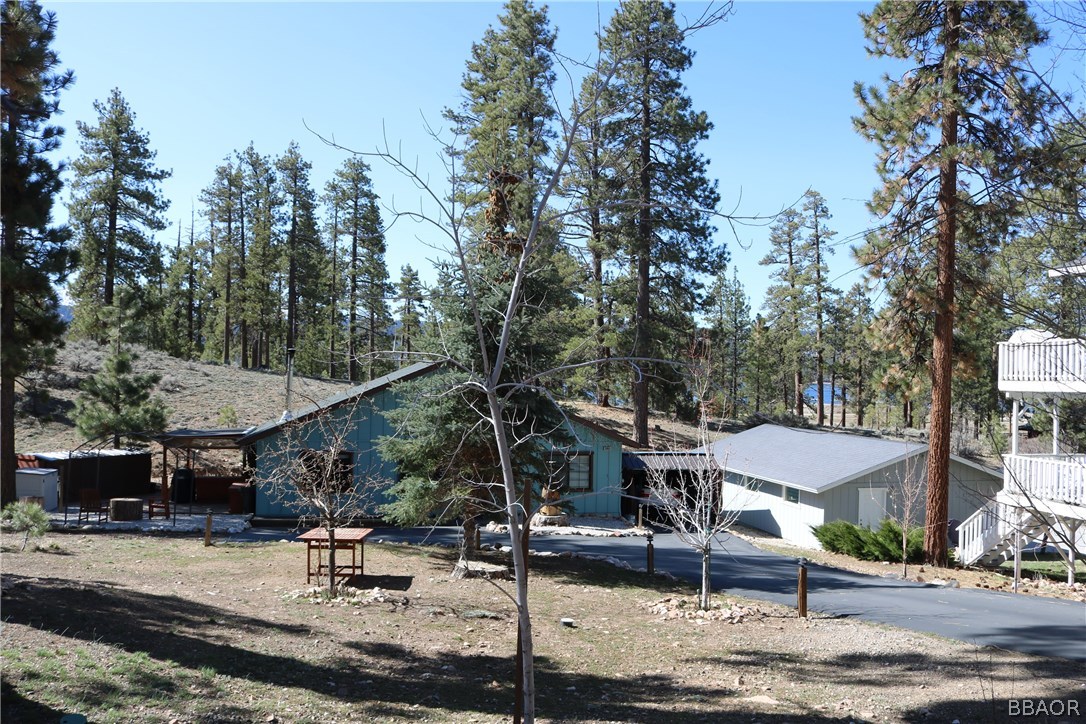 39665 Flicker Road Fawnskin, CA 92333 - Photo 27 of 29 a view of the patio with a table and chairs under an umbrella