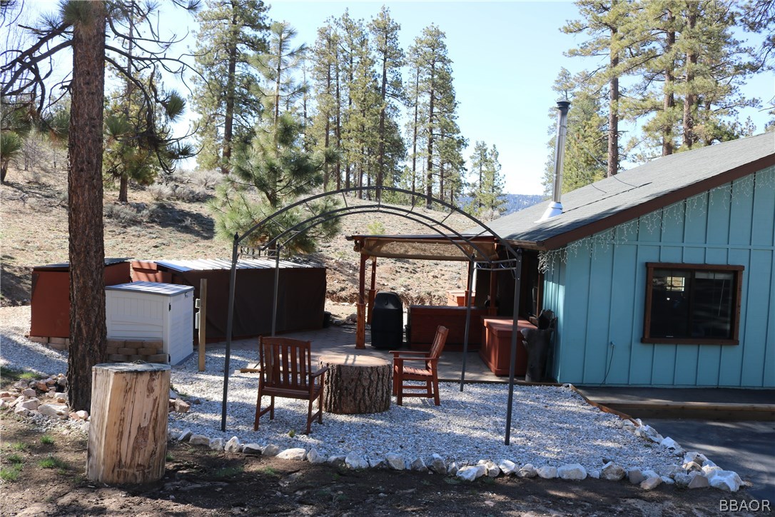 39665 Flicker Road Fawnskin, CA 92333 - Photo 28 of 29 a front view of a house with a yard glass top table and chairs