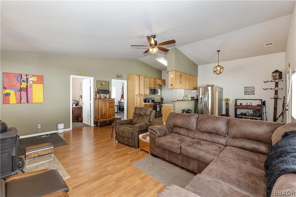 39665 Flicker Road Fawnskin, CA 92333 - Photo 6 of 29 a living room with furniture kitchen view and a wooden floor