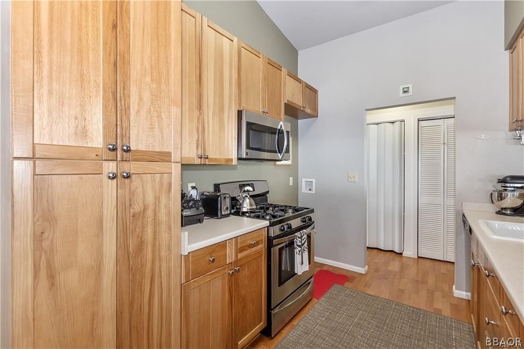 39665 Flicker Road Fawnskin, CA 92333 - Photo 8 of 29 a kitchen with stainless steel appliances a stove a sink and a refrigerator