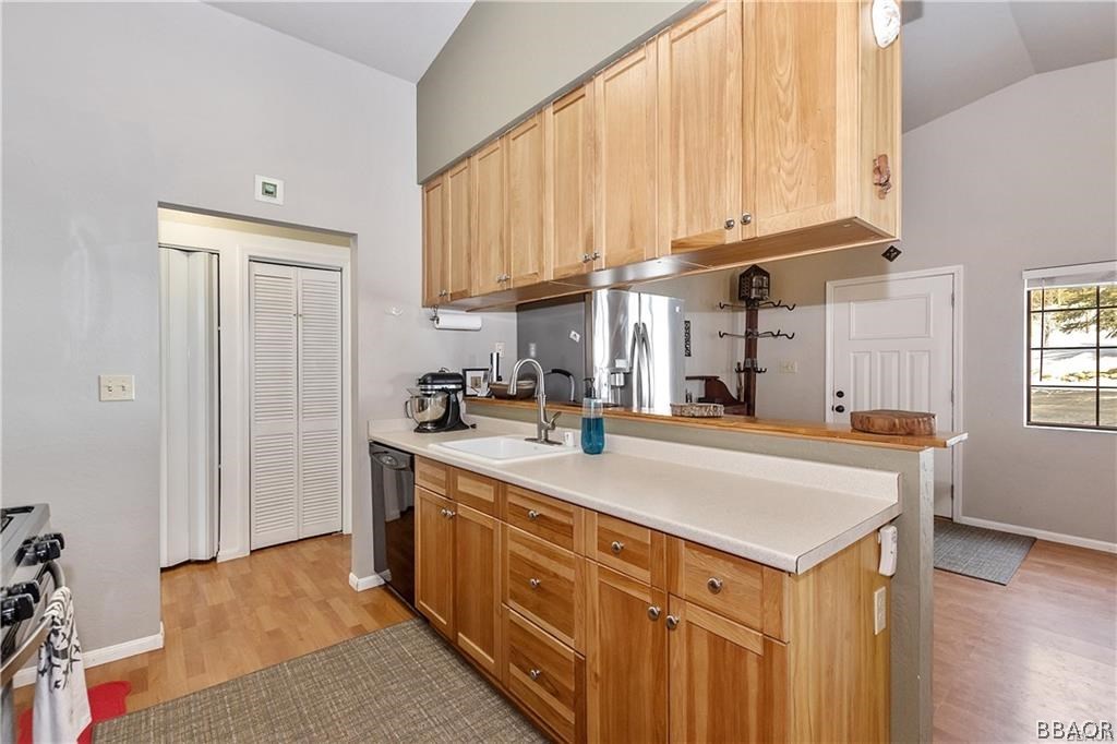 39665 Flicker Road Fawnskin, CA 92333 - Photo 9 of 29 a kitchen with stainless steel appliances granite countertop a sink a stove and a refrigerator
