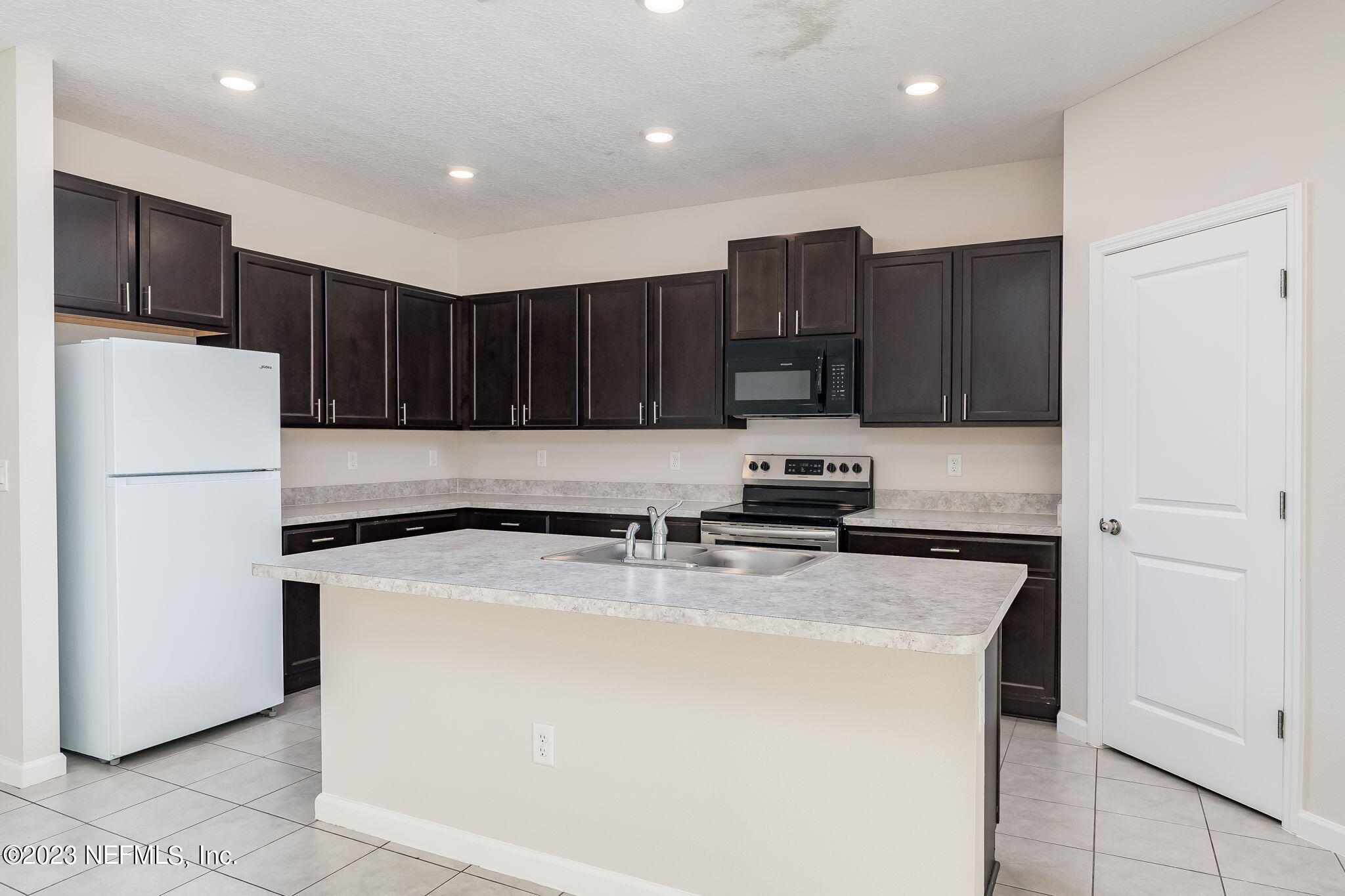 5556 Kellar Circle Jacksonville, FL 32218 - Photo 11 of 28 a kitchen with wooden cabinets and white stainless steel appliances