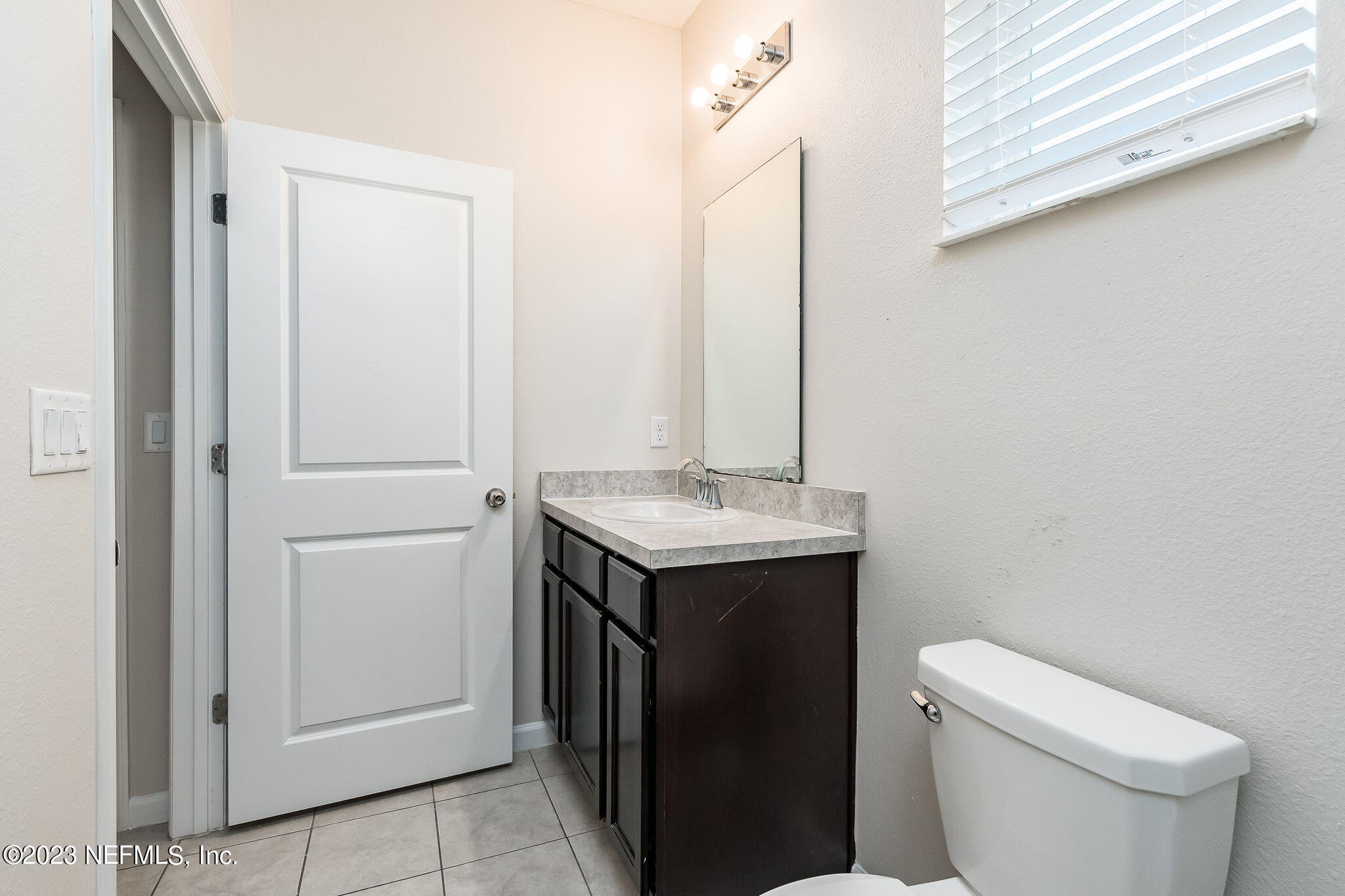 5556 Kellar Circle Jacksonville, FL 32218 - Photo 13 of 28 a bathroom with a sink toilet and vanity