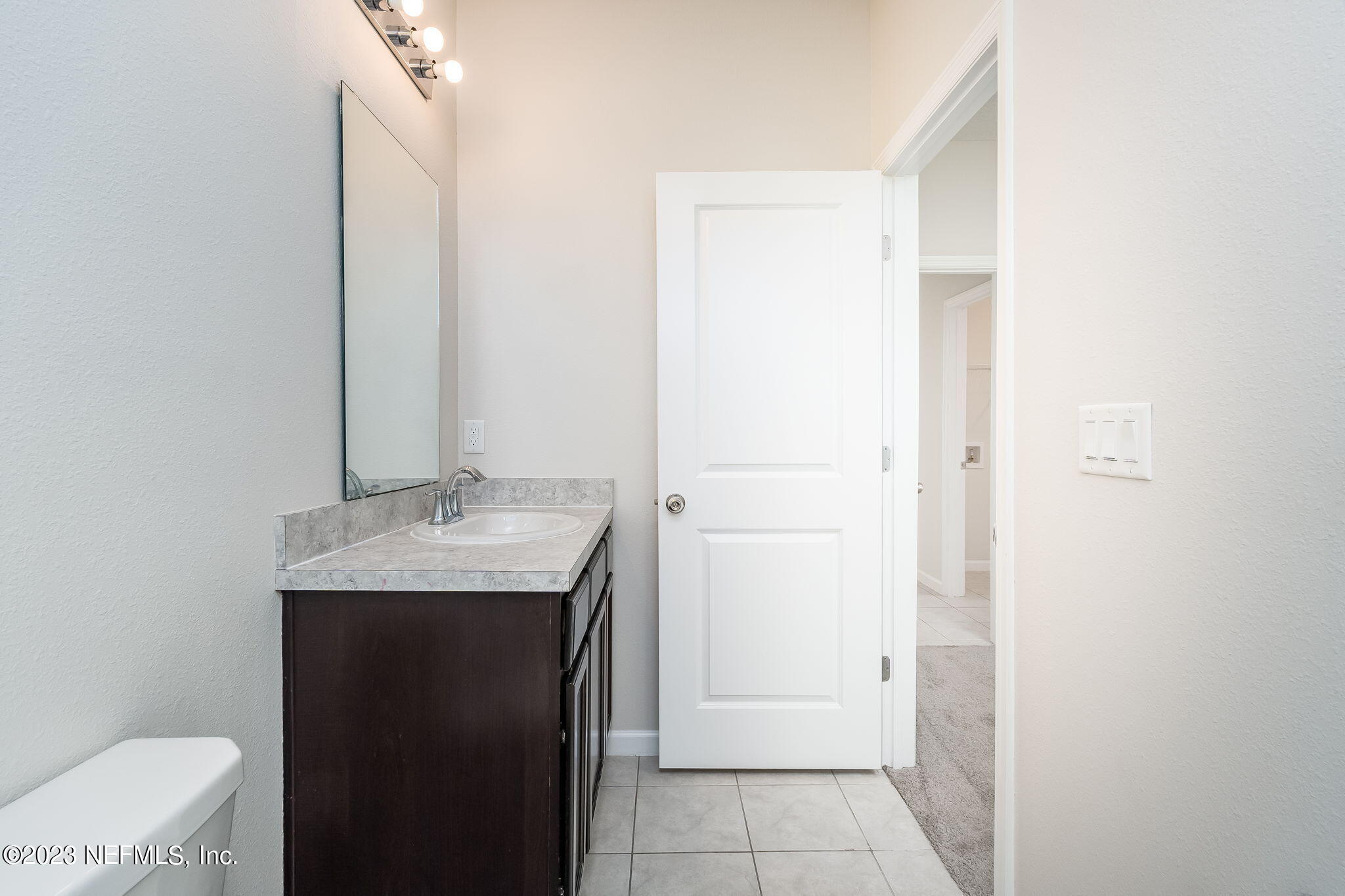 5556 Kellar Circle Jacksonville, FL 32218 - Photo 17 of 28 a bathroom with a granite countertop sink and a mirror