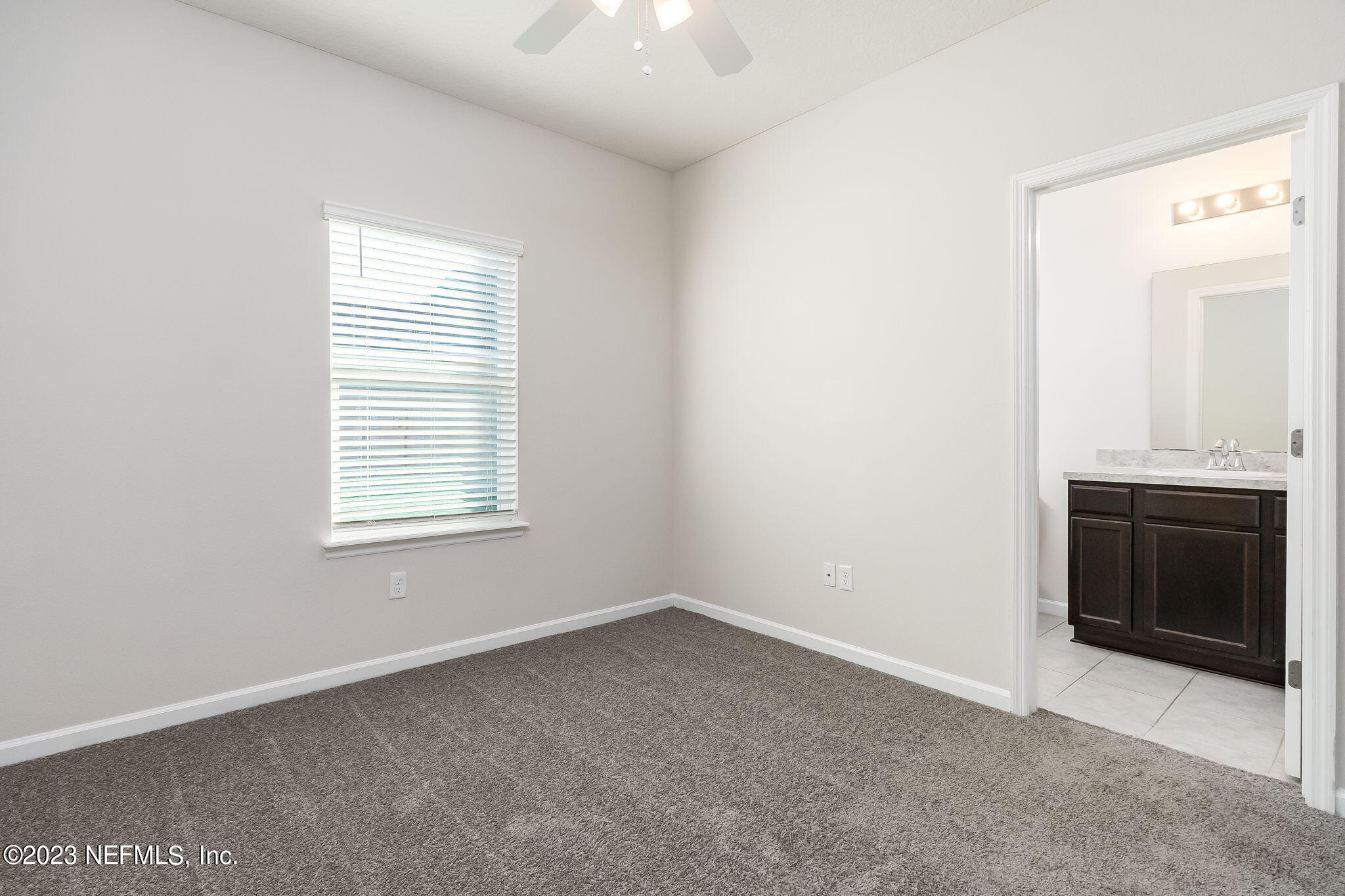 5556 Kellar Circle Jacksonville, FL 32218 - Photo 19 of 28 an empty room with a fireplace and windows