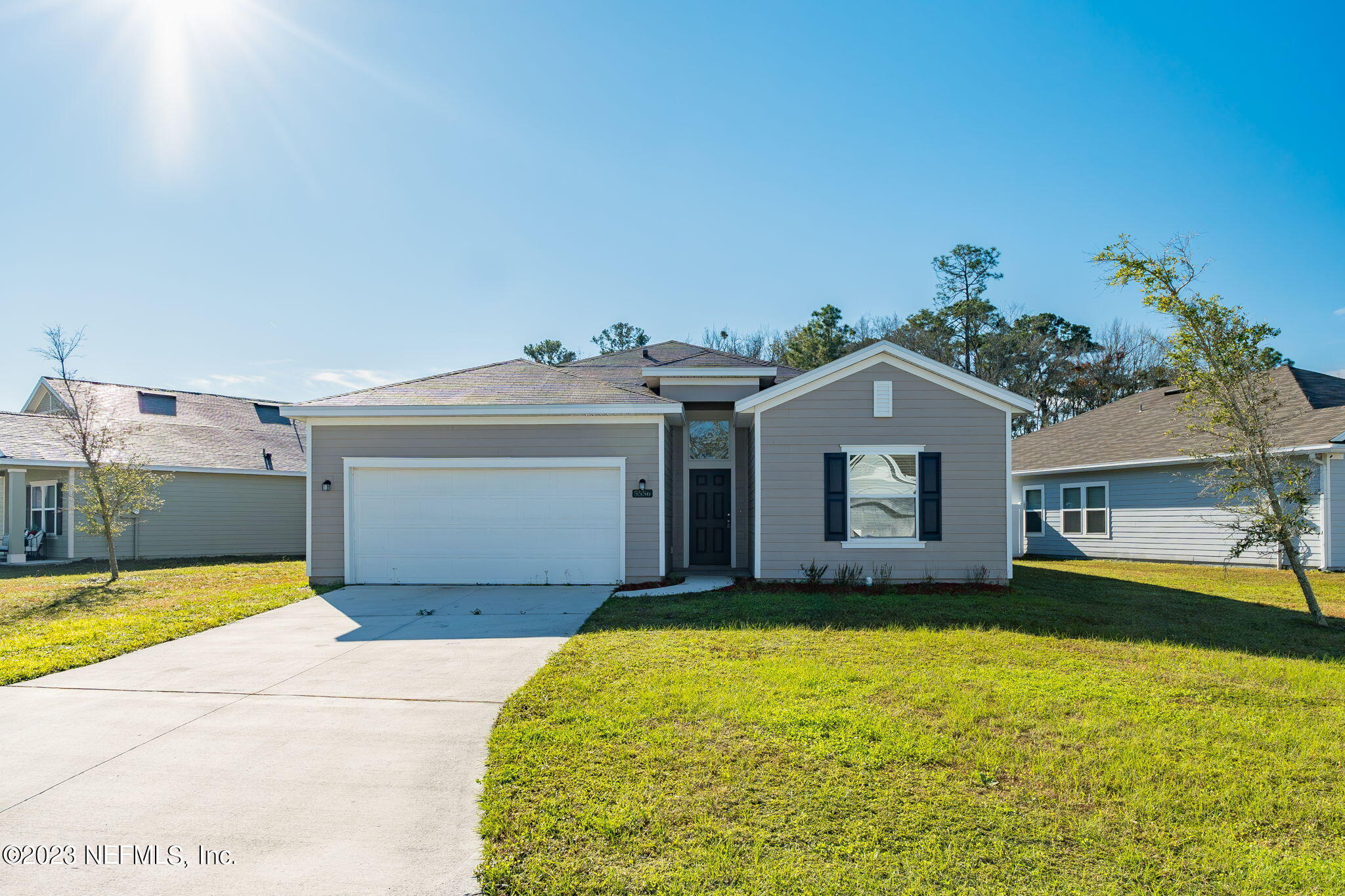 5556 Kellar Circle Jacksonville, FL 32218 - Photo 2 of 28 a front view of a house with a yard and garage