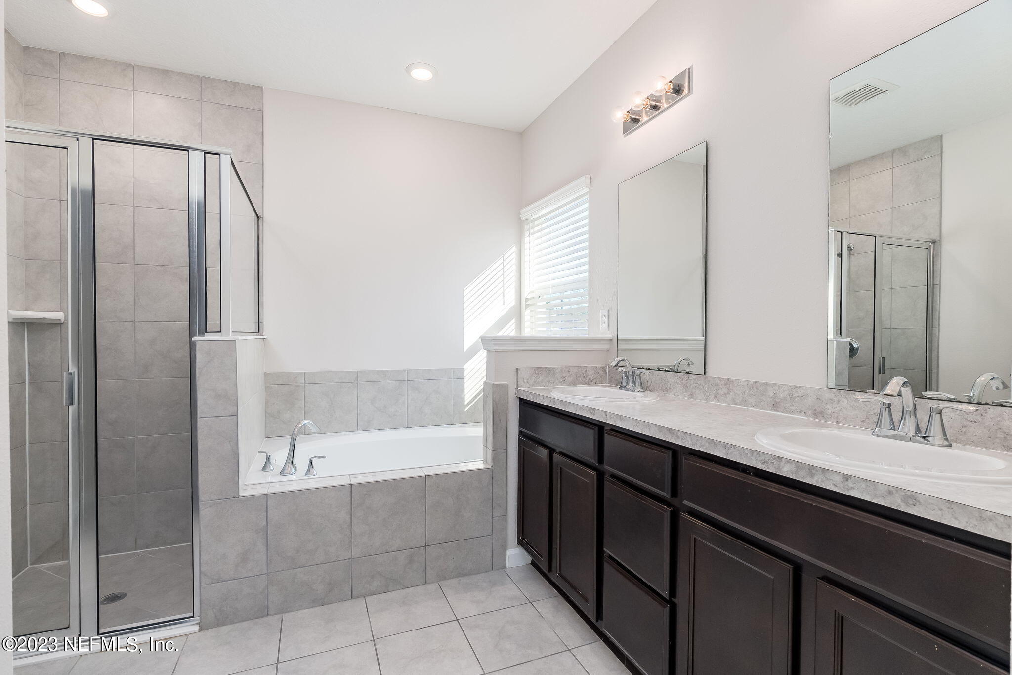 5556 Kellar Circle Jacksonville, FL 32218 - Photo 22 of 28 a bathroom with a granite countertop bathtub sink vanity and mirror