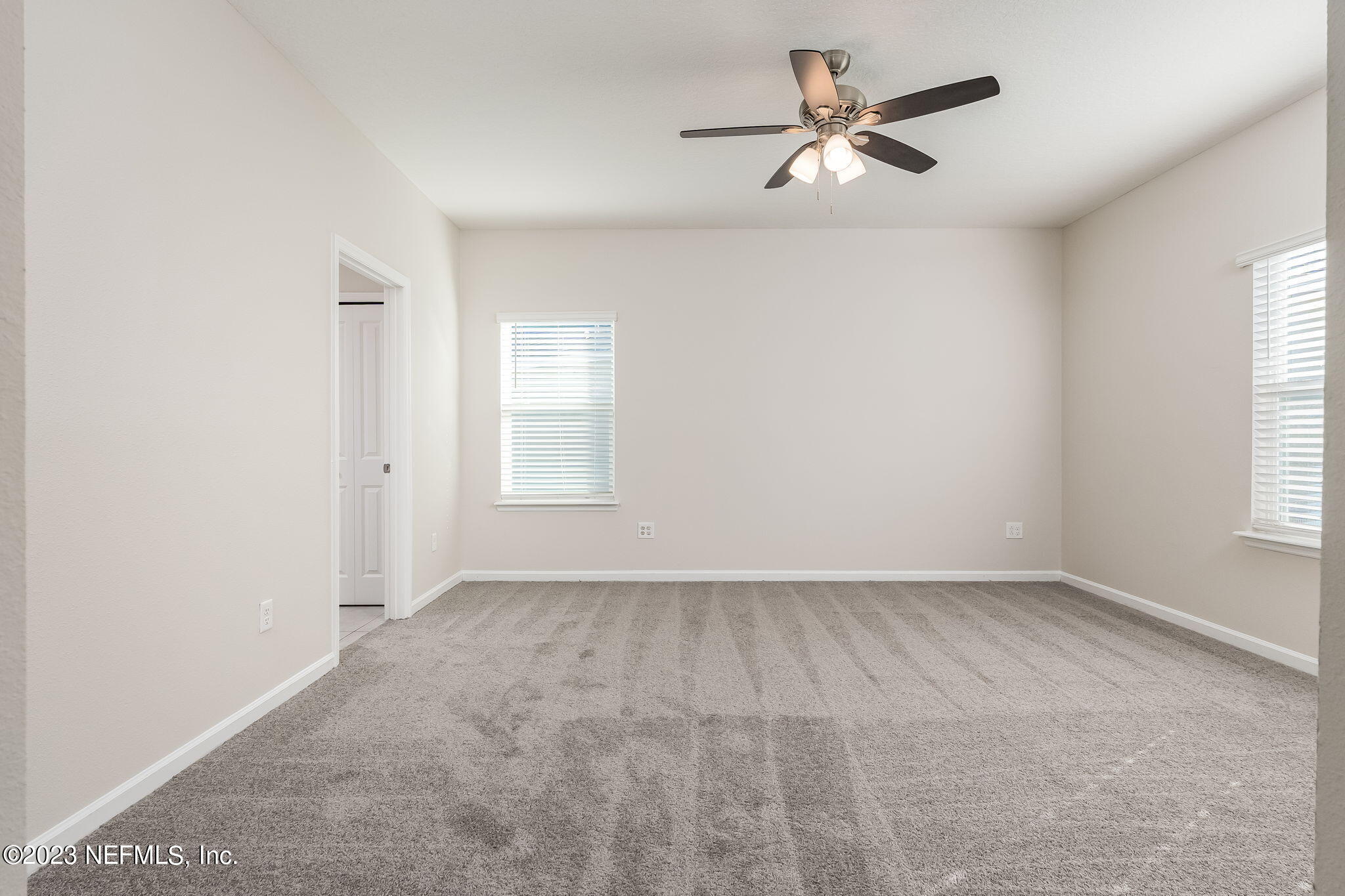 5556 Kellar Circle Jacksonville, FL 32218 - Photo 25 of 28 wooden floor in an empty room with a window