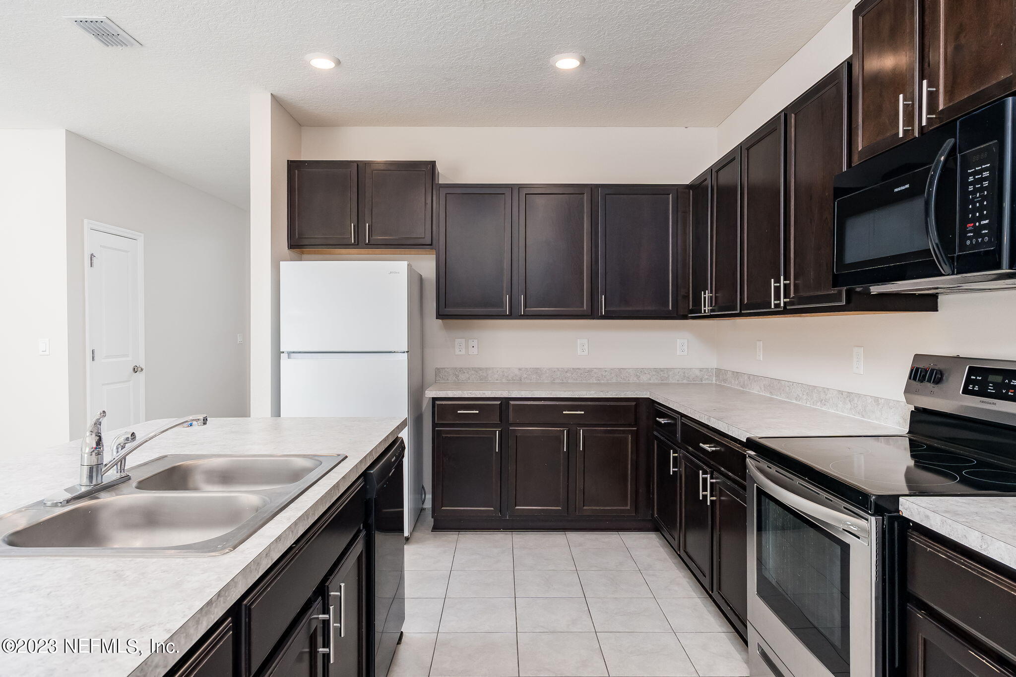 5556 Kellar Circle Jacksonville, FL 32218 - Photo 8 of 28 a kitchen with a sink stove top oven and cabinets