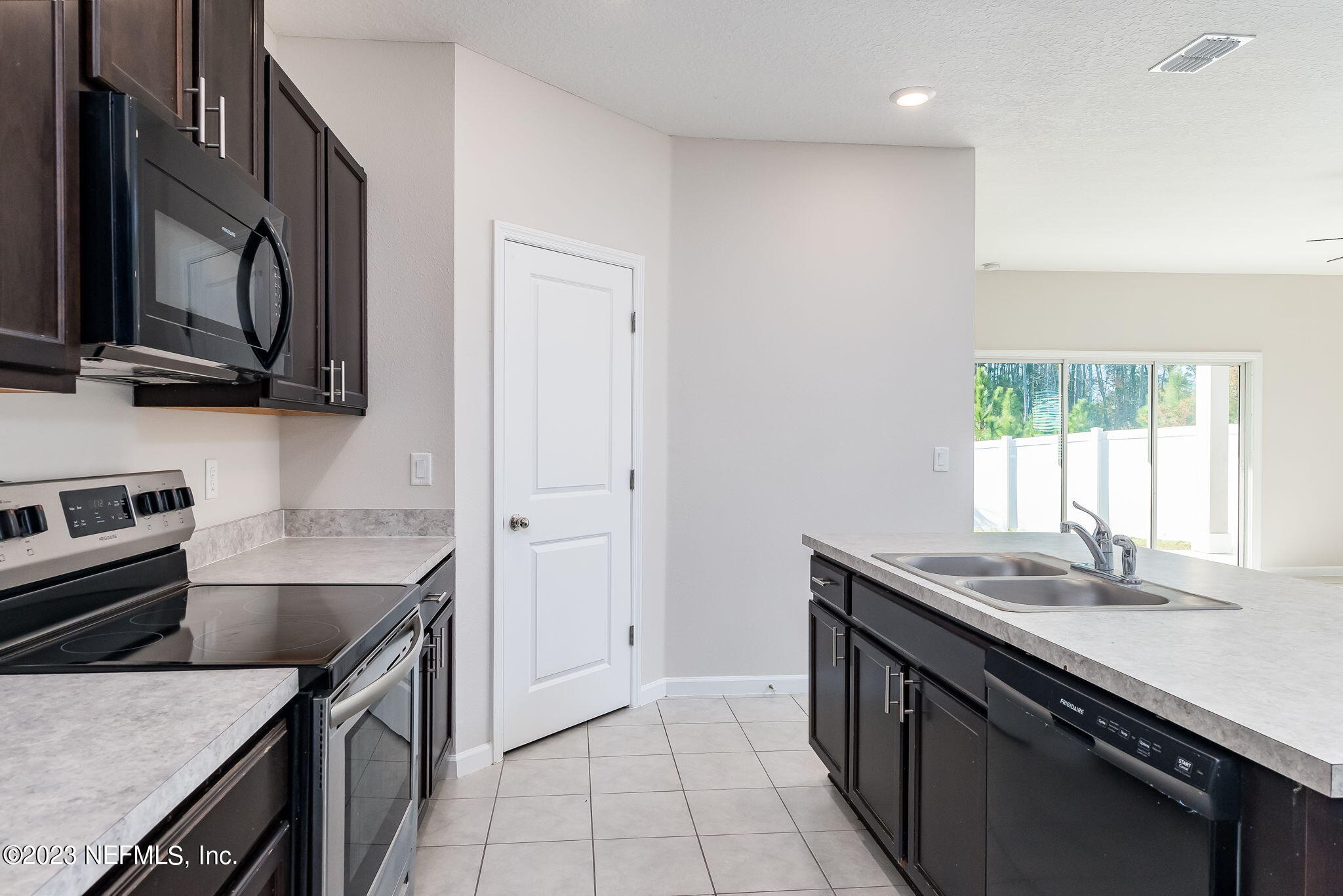5556 Kellar Circle Jacksonville, FL 32218 - Photo 9 of 28 a kitchen with stainless steel appliances granite countertop a sink stove and cabinets