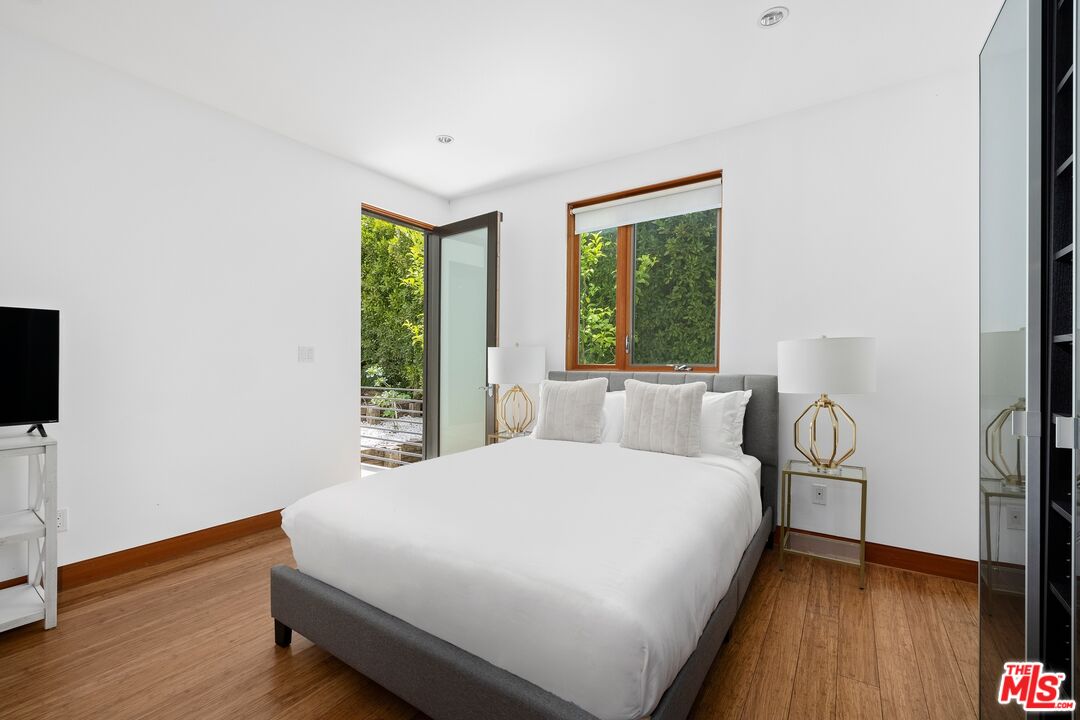 2437 Apollo Drive Los Angeles, CA 90046 - Photo 16 of 27 a large bed sitting in a bedroom next to a window