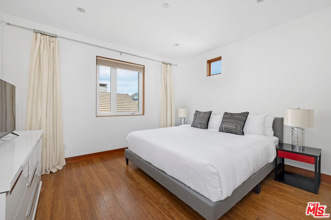 2437 Apollo Drive Los Angeles, CA 90046 - Photo 18 of 27 a large bed sitting in a bedroom next to a window