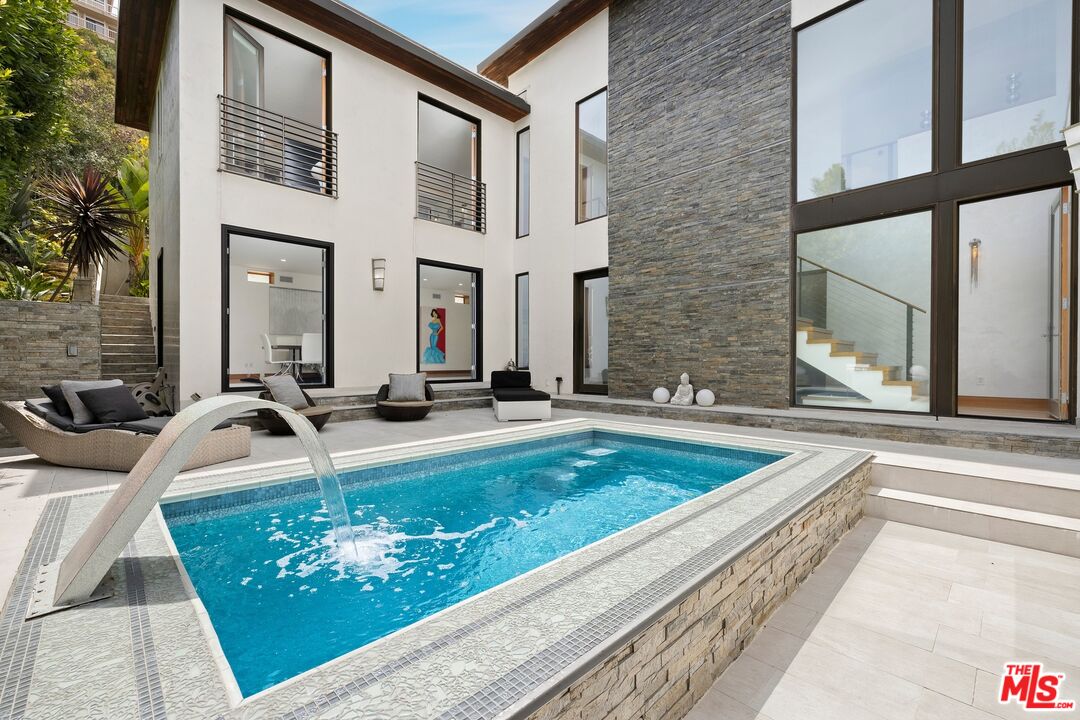2437 Apollo Drive Los Angeles, CA 90046 - Photo 3 of 27 a view of a swimming pool with a chair and tables