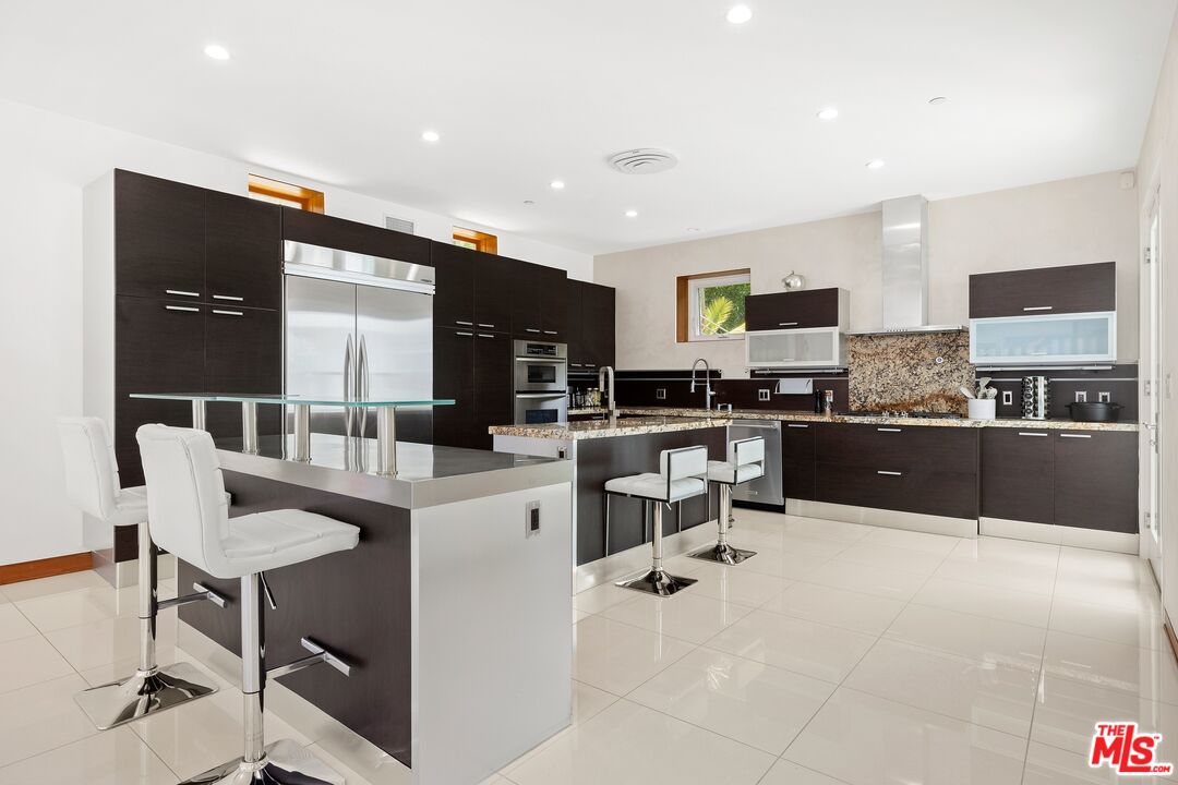 2437 Apollo Drive Los Angeles, CA 90046 - Photo 8 of 27 a kitchen with a sink a counter top space cabinets and stainless steel appliances