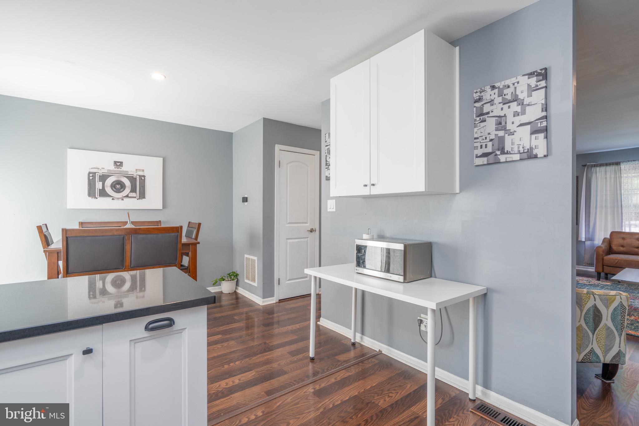 104 Bradbury Road Brookhaven, PA 19015 - Photo 11 of 29 a kitchen with stainless steel appliances cabinets and wooden floor