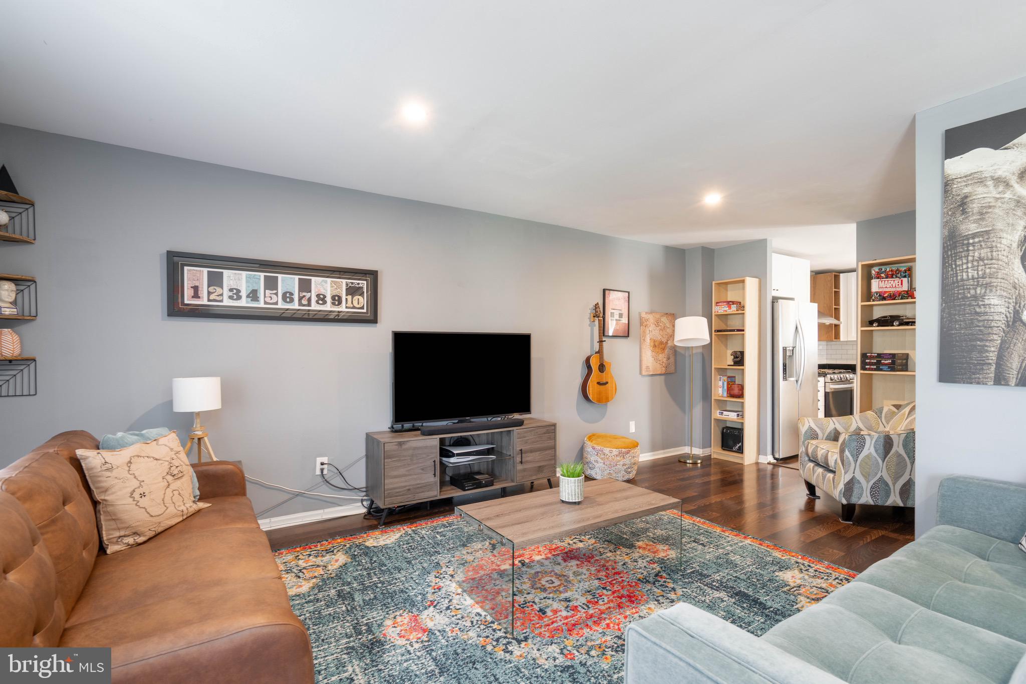 104 Bradbury Road Brookhaven, PA 19015 - Photo 6 of 29 a living room with furniture and a flat screen tv
