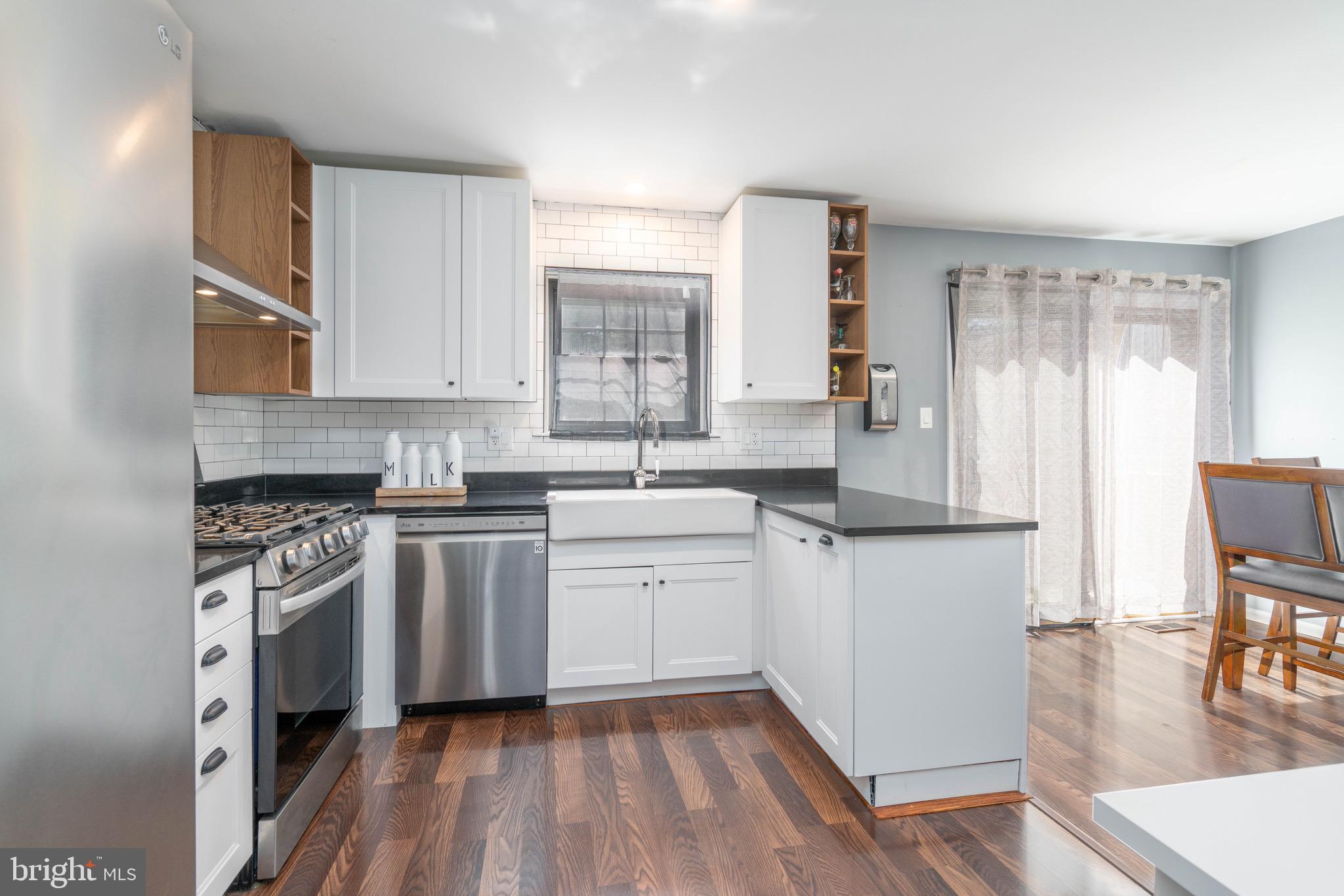 104 Bradbury Road Brookhaven, PA 19015 - Photo 8 of 29 a kitchen with granite countertop white cabinets and white appliances