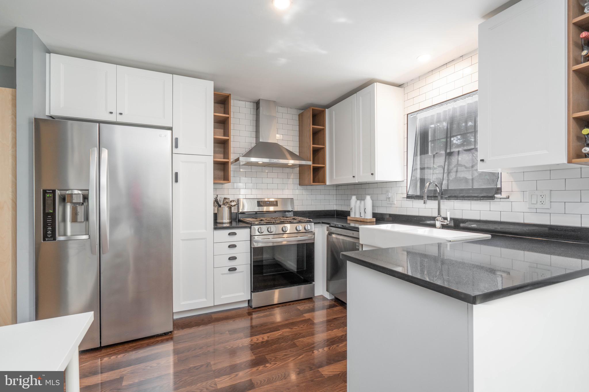 104 Bradbury Road Brookhaven, PA 19015 - Photo 9 of 29 a kitchen with stainless steel appliances granite countertop a refrigerator sink and stove
