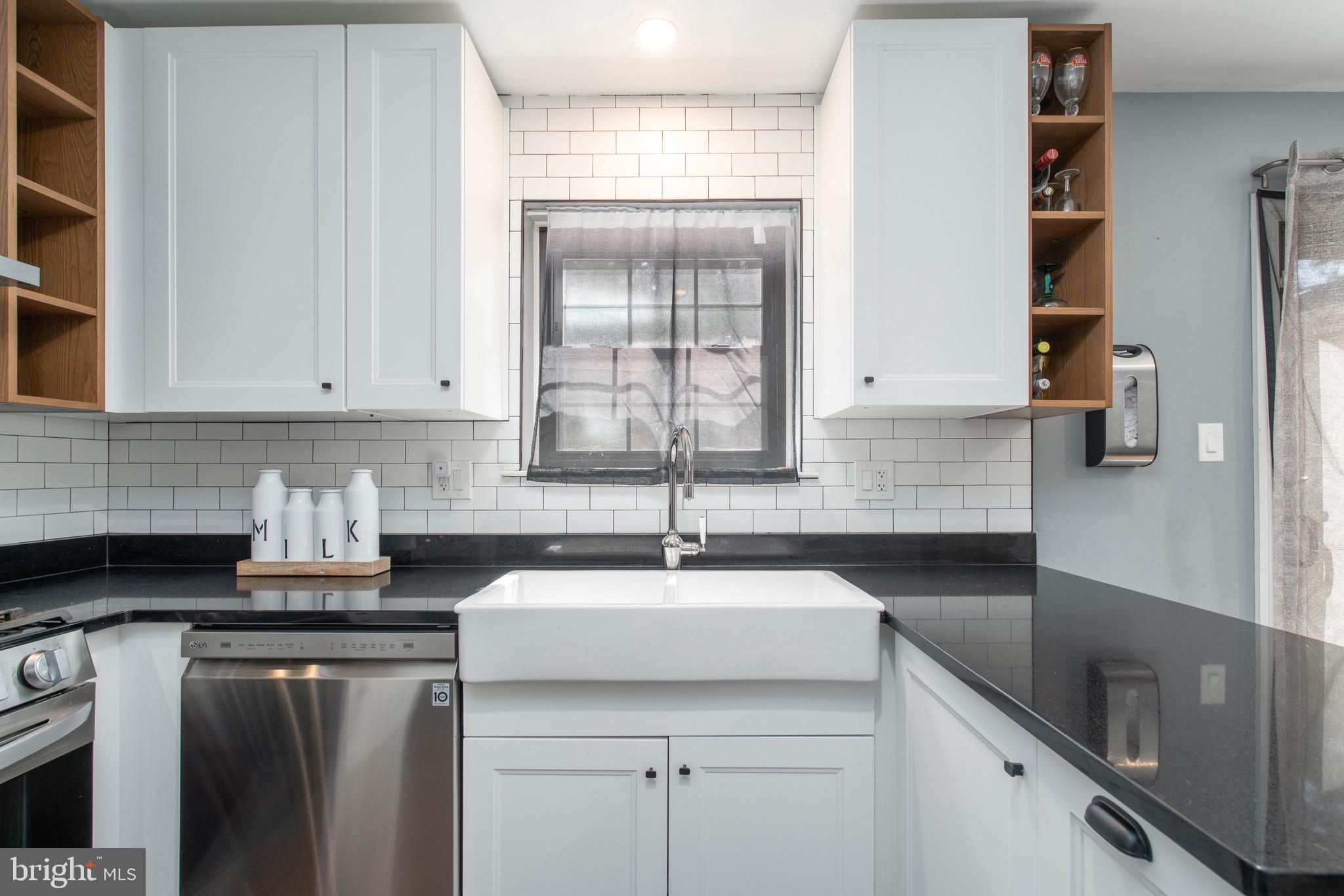 104 Bradbury Road Brookhaven, PA 19015 - Photo 10 of 29 a kitchen with stainless steel appliances granite countertop a sink stove and cabinets