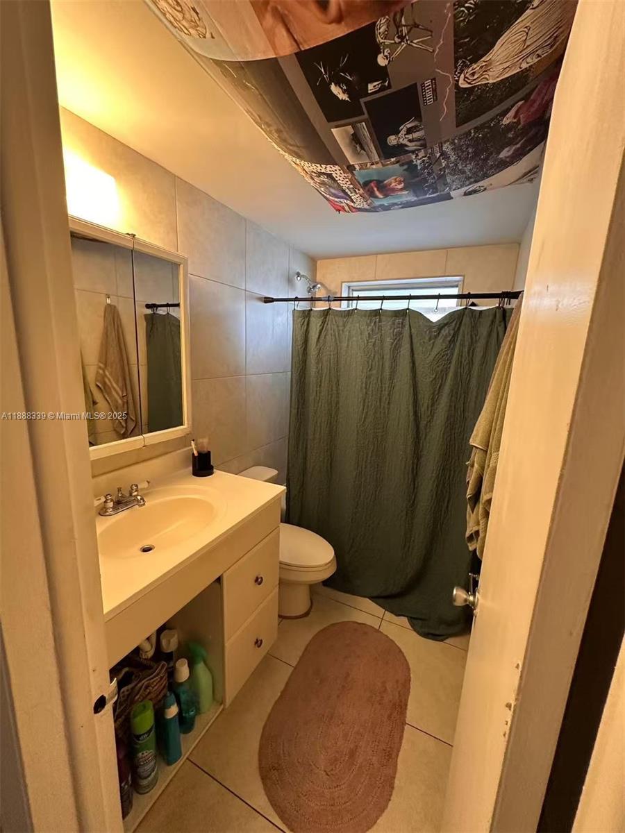 1021 Crystal Lake Drive, Unit 311 Deerfield Beach, FL 33064 - Photo 11 of 17 a bathroom with a sink and mirror