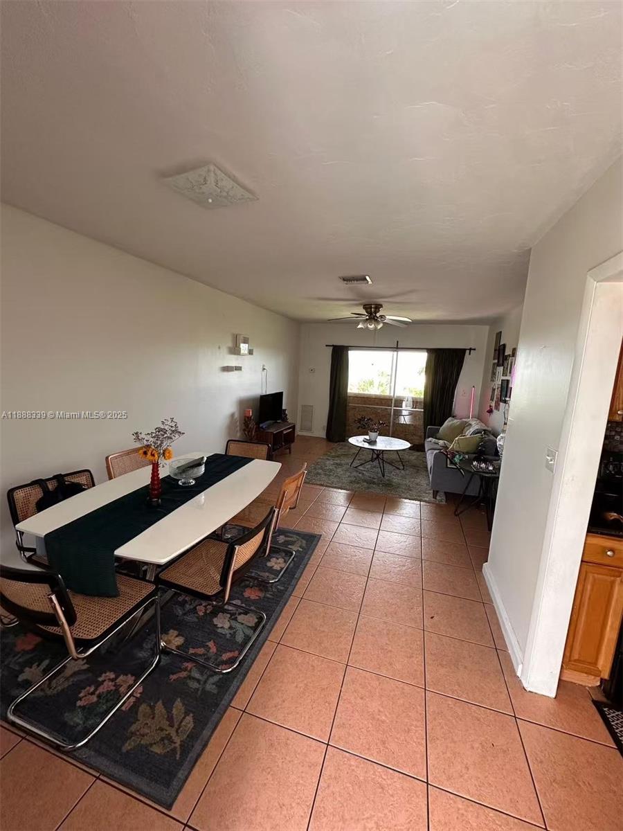 1021 Crystal Lake Drive, Unit 311 Deerfield Beach, FL 33064 - Photo 4 of 17 a room with gym equipment and a view of living room