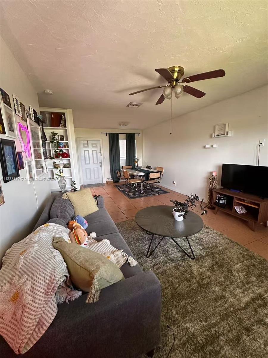 1021 Crystal Lake Drive, Unit 311 Deerfield Beach, FL 33064 - Photo 5 of 17 a bed room with a bed a couch and a television