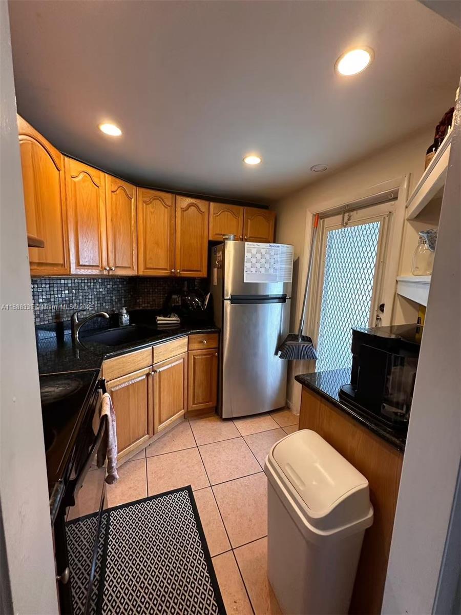 1021 Crystal Lake Drive, Unit 311 Deerfield Beach, FL 33064 - Photo 7 of 17 a kitchen with a sink and a stove top oven