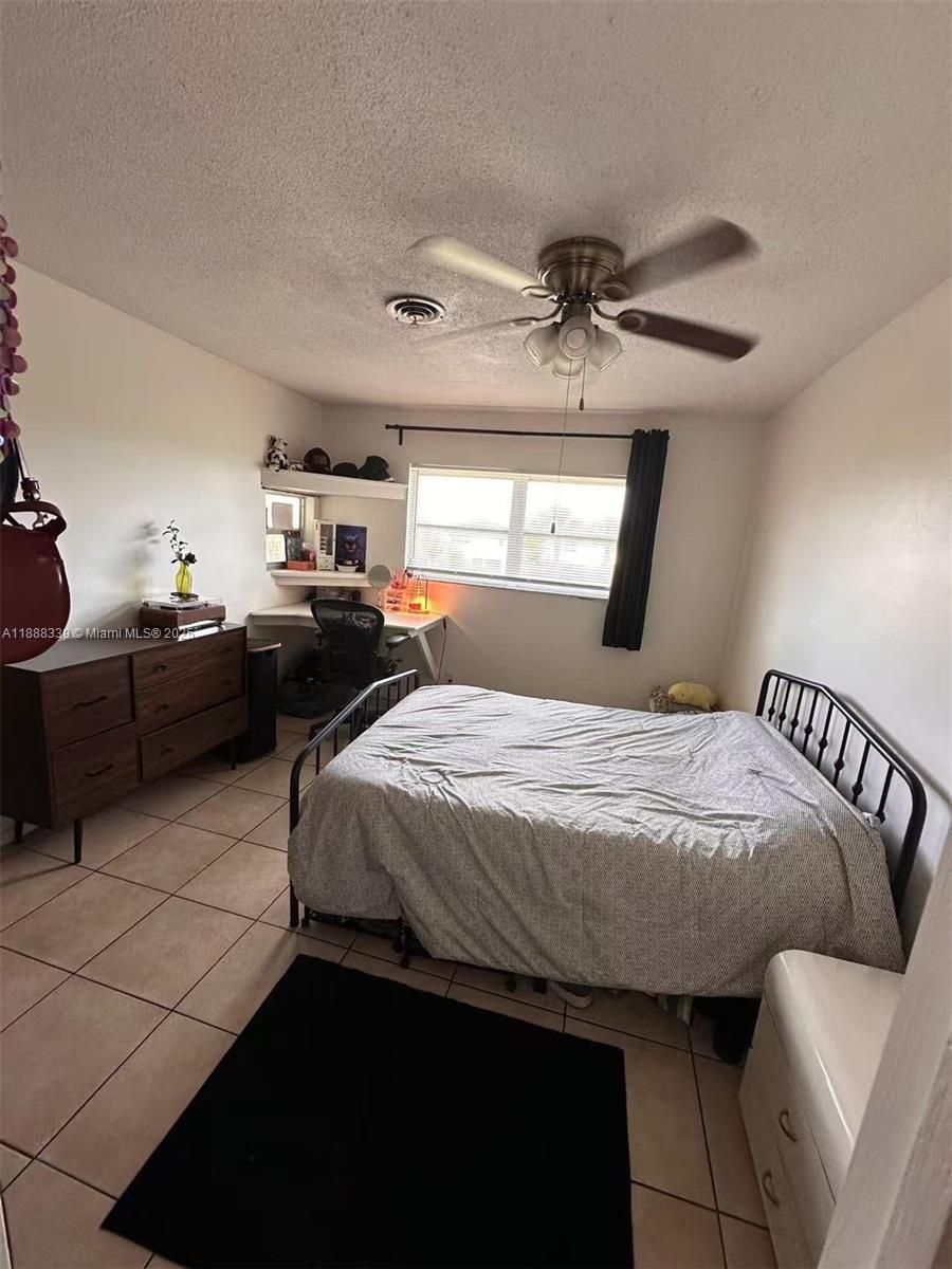 1021 Crystal Lake Drive, Unit 311 Deerfield Beach, FL 33064 - Photo 8 of 17 a bedroom with a bed and window