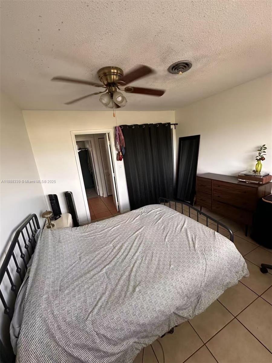 1021 Crystal Lake Drive, Unit 311 Deerfield Beach, FL 33064 - Photo 9 of 17 a bed sitting in a bedroom and a mirror