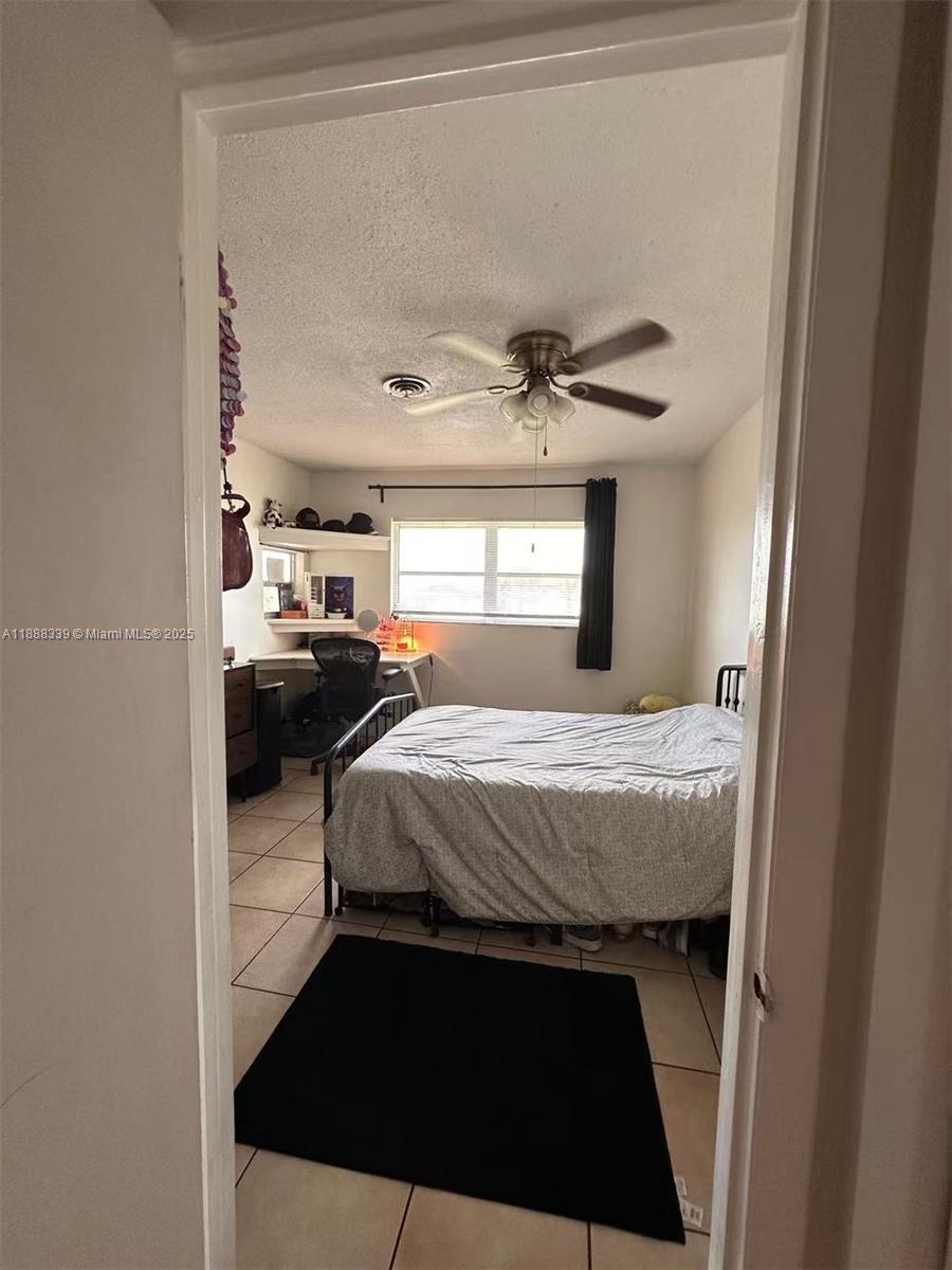 1021 Crystal Lake Drive, Unit 311 Deerfield Beach, FL 33064 - Photo 10 of 17 a bedroom with a bed and window