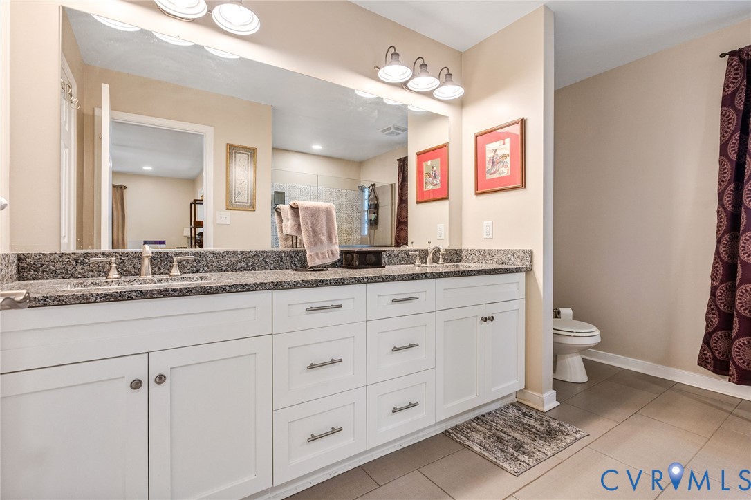 1373 Butler Branch Road Petersburg, VA 23805 - Photo 16 of 28 Bathroom with double vanity, a stall shower, and l