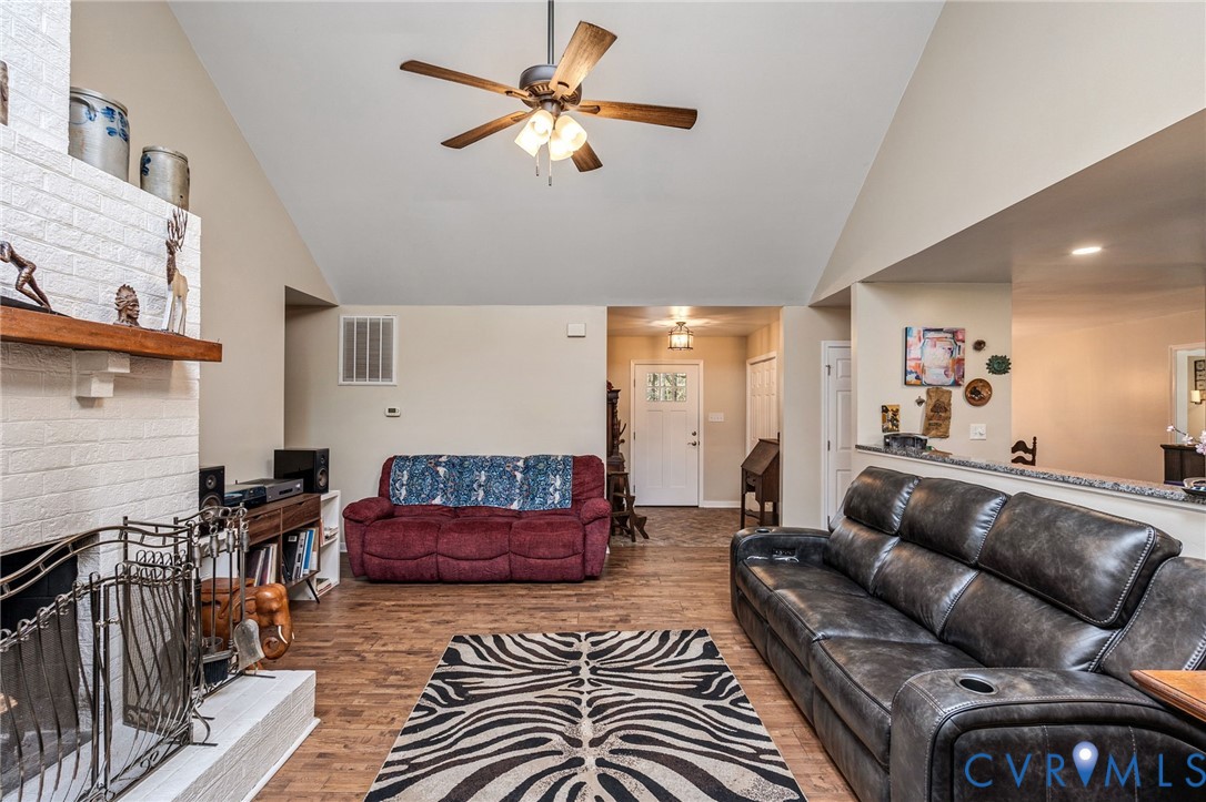1373 Butler Branch Road Petersburg, VA 23805 - Photo 4 of 28 Living room with a fireplace, light wood-style flo