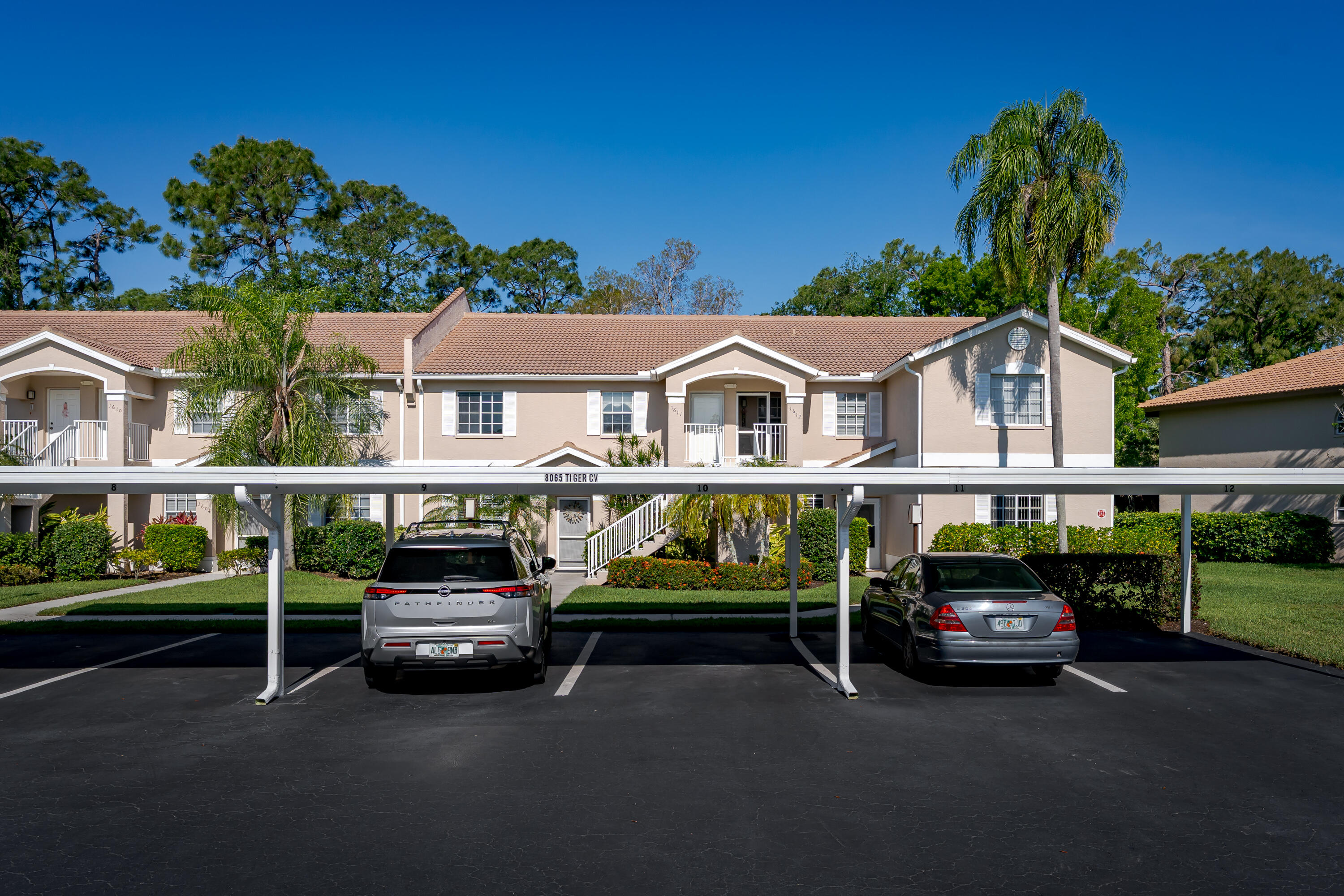 8065 Tiger Cove, Unit 1611 Naples, FL 34113 - Photo 5 of 40 Front of condo, view of parking and fr