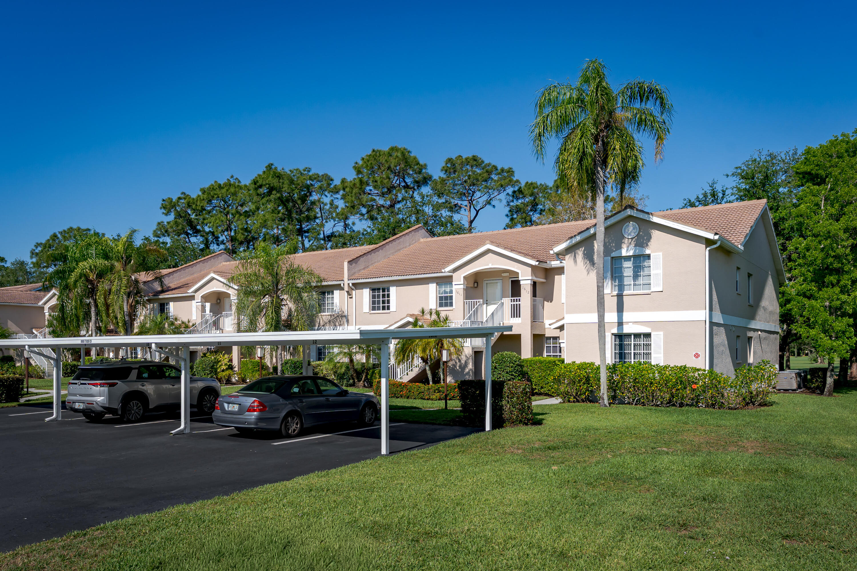8065 Tiger Cove, Unit 1611 Naples, FL 34113 - Photo 6 of 40 Front of condo, view of parking and fr