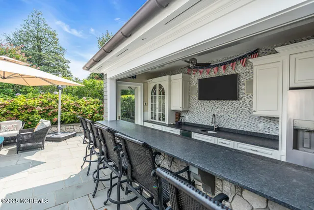 a view of a house with sitting area and swimming pool