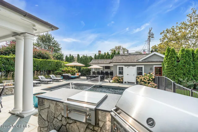 a view of a house with swimming pool and sitting area