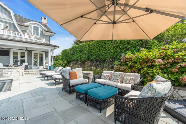 a view of a kitchen with stainless steel appliances granite countertop a sink a refrigerator and a stove
