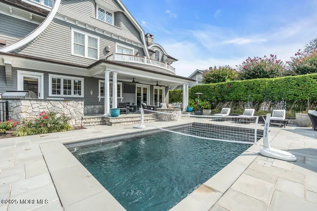 a kitchen with stainless steel appliances granite countertop a sink a stove and a wooden floor
