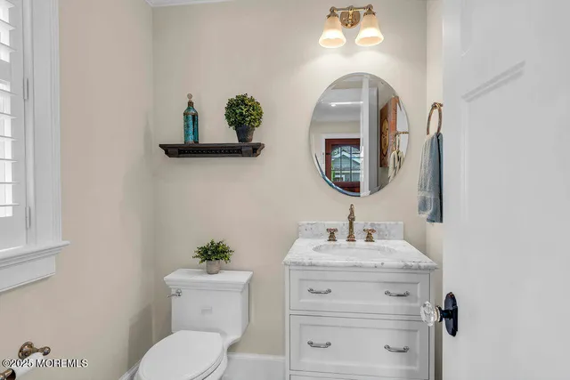 a bedroom with a bed and a lamp on dresser