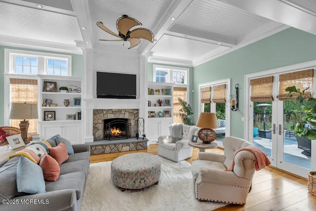 a view of a hallway with wooden floor and a bathroom